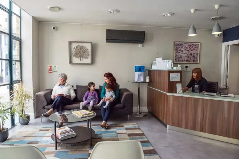 a group of people sitting on a couch in the 92 Dental waiting room in Hammersmith